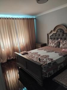 a bedroom with a large bed with a large bed frame at Residence Manu Tg Neamț in Târgu Neamț