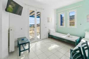 a living room with a couch and a flat screen tv at Villa Zefiros in Kipri
