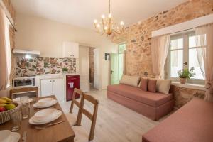 a living room with a couch and a table at Amalthea Guest House in Egina