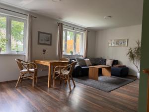 a living room with a couch and a table at Ferienhaus Malte Büsch in Barlt