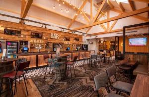 a bar with tables and chairs in a restaurant at Luxury Family Caravan St Osyth Beach Clacton on Sea in Saint Osyth