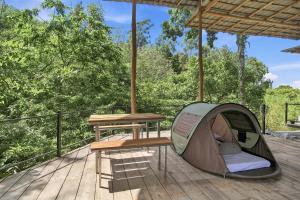 a tent and a picnic table on a deck at Jungle Nest Ella in Ella +11 photos