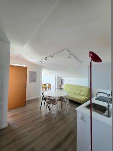 a living room with a table and a couch at mansarda fronte mare in Potenza Picena