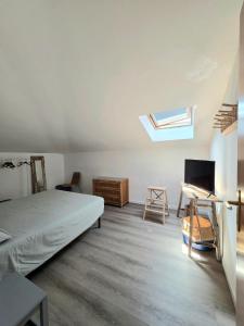 a bedroom with a bed and a desk and a window at mansarda fronte mare in Potenza Picena