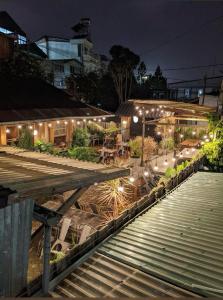 a building with lights on the side of it at night at House 1994 in Xuan An