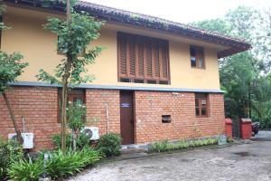 a brick house with a tree in front of it at Luxury Villa Large Private Pool in Raichak