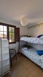 a room with two bunk beds and a chair at Alojamiento Oviedo 2 con parking in Oviedo