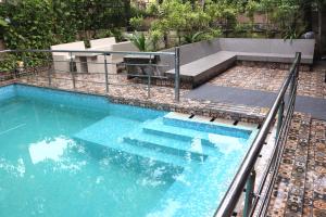 a swimming pool with blue water and stairs in it at Luxury Villa Large Private Pool in Raichak