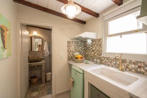a bathroom with a sink and a window at Amalthea Guest House in Egina +31 photos