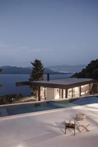 a modern house with a view of the ocean at Ukino House in Nikiana