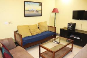 a living room with a couch and a coffee table at Luxury Villa Large Private Pool in Raichak