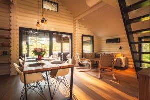 a dining room and living room with a table and chairs at Stay North - Ösund in Helsinki