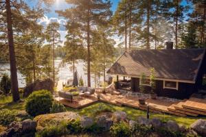 a cabin in the woods next to a lake at Stay North - Ösund in Helsinki