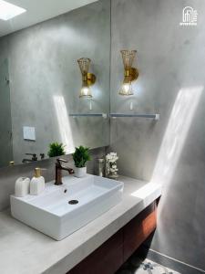 a bathroom with a white sink and a mirror at SolVanya by evaddo stays 2BHK Luxury Villa with Private Pool in Siolim in Siolim