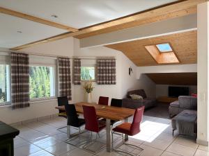 a living room with a wooden table and chairs at Atlantis Apartments by MEIN SAMNAUN - MOUNTAIN HOMES in Samnaun
