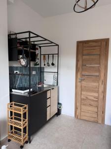 a kitchen with a counter and a wooden door at Zadar Sunhouse Studio with Terrace in Zadar