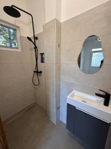 a bathroom with a shower with a sink and a mirror at Zadar Sunhouse Studio with Terrace in Zadar +7 photos