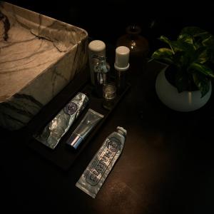 a table with a remote control and other items on it at Chez Colette in Matara