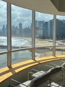a room with a view of a beach and the ocean at Marysol Stay in Busan