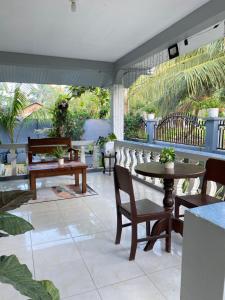 a patio with tables and chairs on a patio at MacCreek in Macrohon