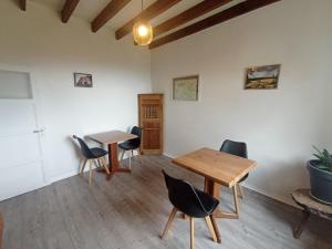 a room with two tables and chairs in it at B&B Les Paddocks in Vollore-Montagne