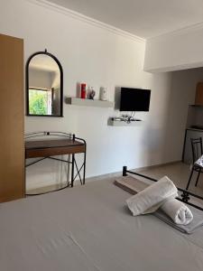 a living room with a bed and a mirror at Joni's house in Piqeras