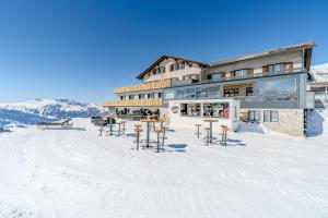 a building on top of a snow covered mountain at Berghotel Hahnenmoos in Adelboden