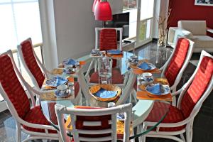 a dining room with a glass table and chairs at Seeperle in Dranske