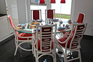 a dining room table with four chairs around it at Seeperle in Dranske