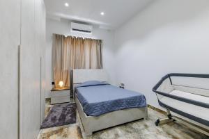 a small bedroom with a bed and a window at Bayleaf Coastal Apartment in Marsaxlokk +7 photos