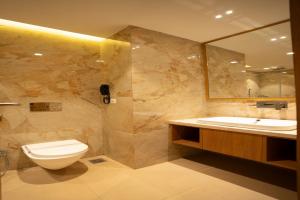 a bathroom with a toilet and a sink at Tirupati Resorts in Kota