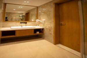 a bathroom with a sink and a mirror at Tirupati Resorts in Kota
