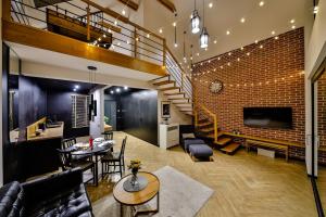 a living room with a staircase and a brick wall at Loftowe Zacisze in Bystra