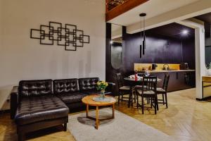 a living room with a couch and a table at Loftowe Zacisze in Bystra