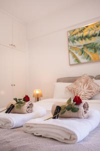 two beds with towels on them in a bedroom at Cozy Apartment in Paphos Beautiful Complex in Paphos