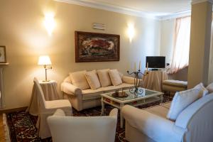 a living room with a couch and a table at Albergo Castiglione Langhe in Castiglione Tinella