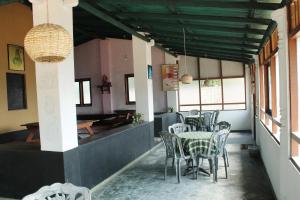 a dining room with a table and chairs at Akurala Beach Park in Hikkaduwa