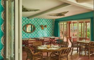 a dining room with tables and chairs and a mirror at Hermitage Hotel & Resort Forte dei Marmi - Starhotels Collezione in Forte dei Marmi