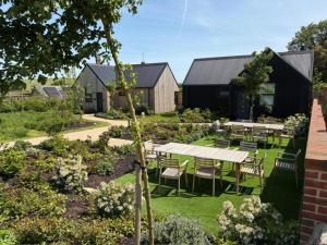 a garden with tables and chairs in the grass at Eve in Marlborough