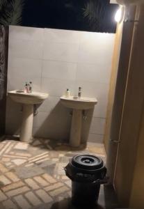 a bathroom with two sinks and a toilet in it at منتجع النادر الريفي in Az Zulfi +25 photos