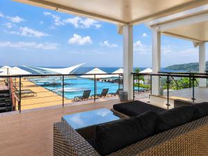 a living room with a couch on a balcony at Karon Utopia in Karon Beach