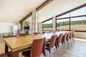 a large dining room with a long table and chairs at Cal Potret in Argençola