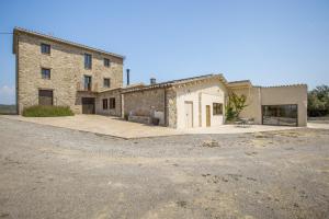a large stone building with a driveway in front of it at Cal Potret in Argençola
