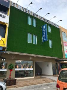 a large green building with a sign on it at Elmark Hotel Kuantan in Kuantan