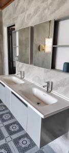 a bathroom with two sinks and a mirror at VNJ Capsule 216 in Hoi An +37 photos