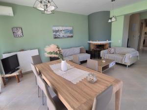 a living room with a wooden table and a couch at Seaside Vatera in Vatera