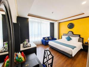 a hotel room with a bed and a mirror at Aurora Hotel SaPa in Sapa