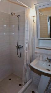 a bathroom with a shower and a sink at Amir Guesthouse in Chon-Dzhargylchak +27 photos
