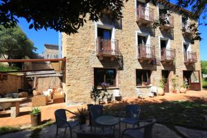 a building with chairs and a table in front of it at Nascar Hotel in Santa Maria Navarrese