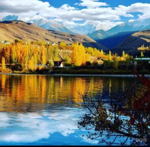 a view of a lake with mountains in the background at Amir Guesthouse in Chon-Dzhargylchak